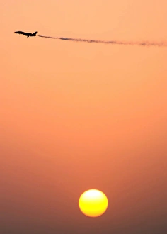 An F-14D Tomcat dumps fuel prior to a sunset landing An F-14D Tomcat dumps fuel prior to a sunset landing