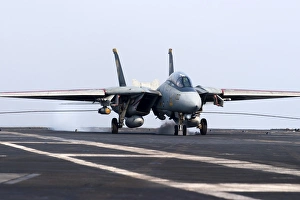 An F-14D Tomcat makes an arrested landing on the flight deck of USS Theodore Roosevelt An F-14D Tomcat makes an arrested landing on the flight deck of USS Theodore Roosevelt