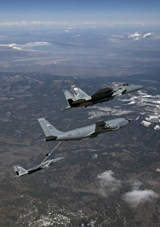 Two F-15 Eagles conduct aerial refueling with a KC-135 Stratotanker Two F-15 Eagles conduct aerial refueling with a KC-135 Stratotanker