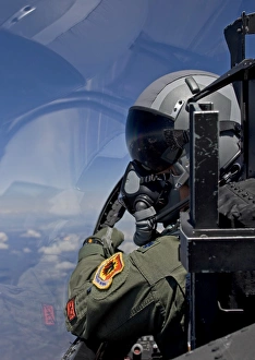A F-15 pilot looks over at his wingman while in flight A F-15 pilot looks over at his wingman while in flight