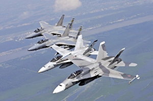 Two F/A-18 Hornets and two F-15 Strike Eagles fly in an echelon formation Two F/A-18 Hornets and two F-15 Strike Eagles fly in an echelon formation