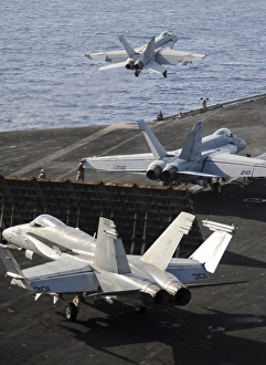 F/A-18 Hornets prepare to launch from the flight deck of USS Nimitz F/A-18 Hornets prepare to launch from the flight deck of USS Nimitz