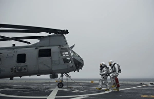 Firefighters approach a CH-46 Sea Knight to simulate a rescue Firefighters approach a CH-46 Sea Knight to simulate a rescue
