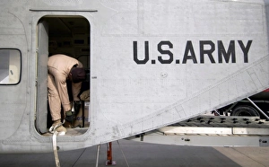 Flight Engineer secures equipment inside the cargo compartment of his C-23B Sherpa Flight Engineer secures equipment inside the cargo compartment of his C-23B Sherpa