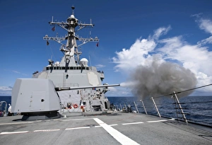 Guided-missile destroyer USS Pinckney fires its MK-45 5-inch/54-caliber gun Guided-missile destroyer USS Pinckney fires its MK-45 5-inch/54-caliber gun