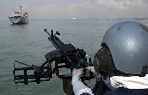 A gunner keeps his sight on the Military Sealift Command combat stores ship USNS Concord A gunner keeps his sight on the Military Sealift Command combat stores ship USNS Concord