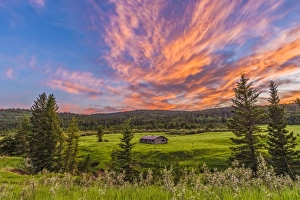 A high dynamic range photo of a sunset over a log cabin A high dynamic range photo of a sunset over a log cabin
