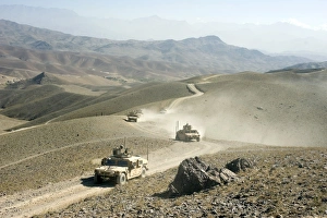 Humvees traverse rugged mountain roads Humvees traverse rugged mountain roads