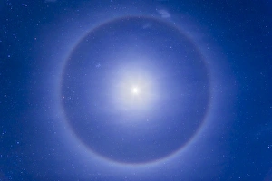 An ice crystal halo around the first quarter moon An ice crystal halo around the first quarter moon
