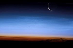This image shows the limb of the Earth at the bottom transitioning into the orange-colored This image shows the limb of the Earth at the bottom transitioning into the orange-colored