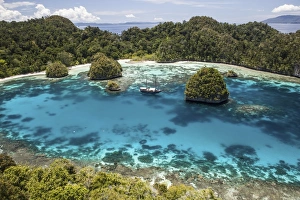 An Indonesian pinisi schooner in a lagoon in Raja Ampat, Indonesia An Indonesian pinisi schooner in a lagoon in Raja Ampat, Indonesia