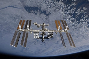 International Space Station set against the background of a cloud covered Earth International Space Station set against the background of a cloud covered Earth