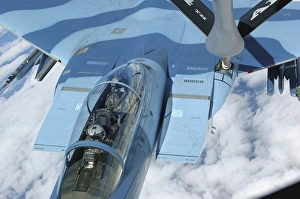 A KC-135 Stratotanker provides in-flight refueling to an F-15 Eagle A KC-135 Stratotanker provides in-flight refueling to an F-15 Eagle