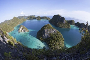 Limestone islands surround a lagoon in a remote part of Raja Ampat Limestone islands surround a lagoon in a remote part of Raja Ampat