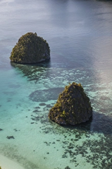 Limestone islands surrounded by a coral reef in Raja Ampat Limestone islands surrounded by a coral reef in Raja Ampat
