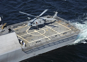 The littoral combat ship USS Freedom with an MH-60S Sea Hawk helicopter The littoral combat ship USS Freedom with an MH-60S Sea Hawk helicopter
