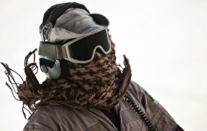 A loadmaster protects his head from the intense heat generated by C-130 Hercules engines A loadmaster protects his head from the intense heat generated by C-130 Hercules engines