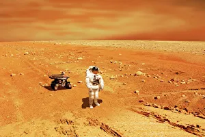 A lone astronaut looks up at the sun while exploring Mars A lone astronaut looks up at the sun while exploring Mars