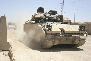 An M2 Bradley Fighting Vehicle patrols past Command Post Hit, Iraq An M2 Bradley Fighting Vehicle patrols past Command Post Hit, Iraq
