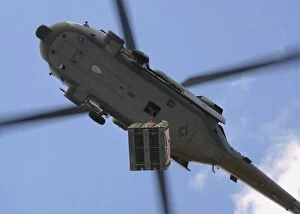 Images Dated 4th November 2005: An MH-60S Seahawk helicopter airlifts a pallet of ammunition