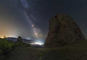 Milky Way over the shining town of Veseloe in Russia Milky Way over the shining town of Veseloe in Russia
