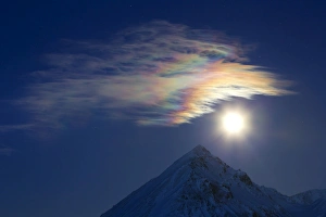 Full moon with rainbow clouds over Ogilvie Mountains, Canada Full moon with rainbow clouds over Ogilvie Mountains, Canada