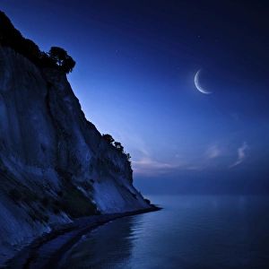 Moon rising over tranquil sea and Mons Klint cliffs, Denmark Moon rising over tranquil sea and Mons Klint cliffs, Denmark