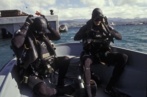 Navy SEALs combat swimmers donn their equipment in a utility boat Navy SEALs combat swimmers donn their equipment in a utility boat
