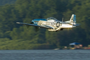 A P-51 Mustang flies along the Mississippi at Dubuque, Iowa A P-51 Mustang flies along the Mississippi at Dubuque, Iowa