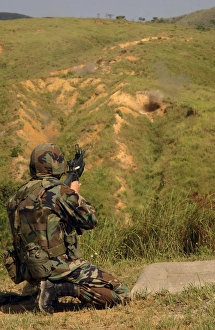 Petty Officer fires off a 40mm Highly Explosive round at Camp Hansen, Okinawa, Japan Petty Officer fires off a 40mm Highly Explosive round at Camp Hansen, Okinawa, Japan