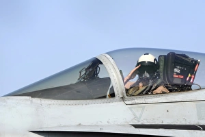 A pilot salutes prior to take off in an F/A-18C Hornet A pilot salutes prior to take off in an F/A-18C Hornet
