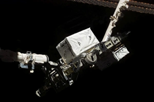 The Remote Manipulator System robotic arm hands-off an external stowage platform The Remote Manipulator System robotic arm hands-off an external stowage platform