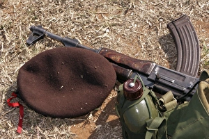 A rifle, military cover and canteen of a Mozambican soldier A rifle, military cover and canteen of a Mozambican soldier