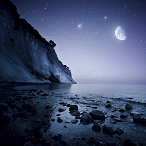 Rising moon over ocean and mountains against starry sky Rising moon over ocean and mountains against starry sky