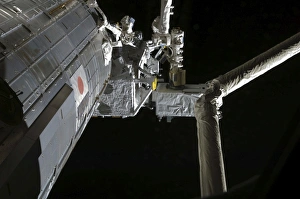 The robotic arm of the Japanese Experiment Module assists in installing components The robotic arm of the Japanese Experiment Module assists in installing components