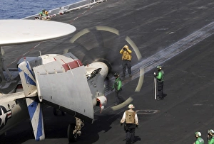 A Sailor directs an E-2C Hawkeye to the catapult aboard the USS Dwight D. Eisenhower A Sailor directs an E-2C Hawkeye to the catapult aboard the USS Dwight D. Eisenhower