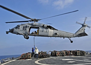 Sailors attach a cargo pennant to a MH-60S Sea Hawk helicopter Sailors attach a cargo pennant to a MH-60S Sea Hawk helicopter