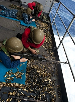 Sailors fire M240 machine guns on the fantail aboard USS John C. Stennis Sailors fire M240 machine guns on the fantail aboard USS John C. Stennis