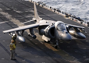 Sailors prepare an AV-8B Harrier jet aircraft for take-off from USS Essex Sailors prepare an AV-8B Harrier jet aircraft for take-off from USS Essex
