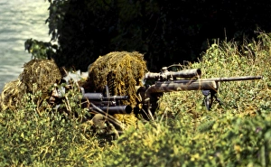 A SEAL Sniper swim pair set up an observation post A SEAL Sniper swim pair set up an observation post