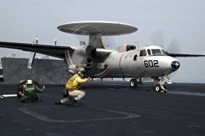 A shooter gives the signal to launch an E-2C Hawkeye A shooter gives the signal to launch an E-2C Hawkeye