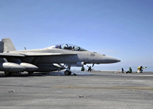A shooter signals the launch of an F/A-18F Super Hornet A shooter signals the launch of an F/A-18F Super Hornet