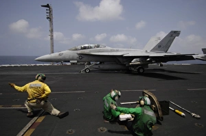 A shooter signals for the launching of an F/A-18F Super Hornet A shooter signals for the launching of an F/A-18F Super Hornet