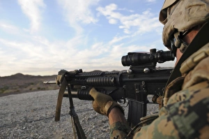 A soldier sights in to fire on a target on a shooting range A soldier sights in to fire on a target on a shooting range