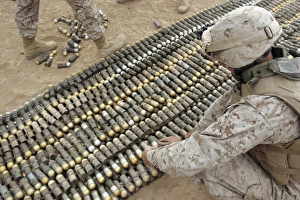 Soldiers arrange all the ordnance confiscated from caches into one big pile to be Soldiers arrange all the ordnance confiscated from caches into one big pile to be