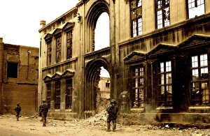 Soldiers patrolling past the facade of a demolished building in Baghdad, Iraq Soldiers patrolling past the facade of a demolished building in Baghdad, Iraq