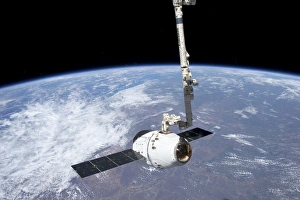The SpaceX Dragon cargo craft in the grasp of the Canadarm2 The SpaceX Dragon cargo craft in the grasp of the Canadarm2
