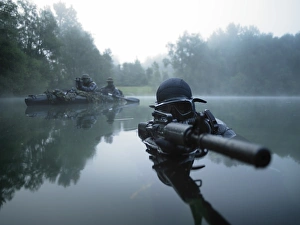 Special operations forces combat diver transits the water armed with an assault rifle Special operations forces combat diver transits the water armed with an assault rifle