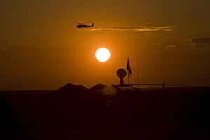 UH-60 Blackhawk flies over Camp Speicher airfield at sunset UH-60 Blackhawk flies over Camp Speicher airfield at sunset