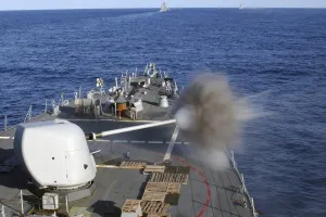 USS Barry fires her forward mounted Mk-45/5 54 caliber lightweight gun USS Barry fires her forward mounted Mk-45/5 54 caliber lightweight gun